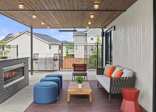 A patio with a fireplace and seating area.