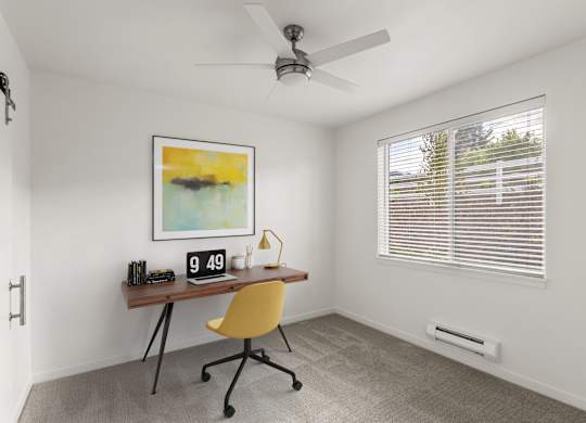 A room with a yellow chair and a painting on the wall.