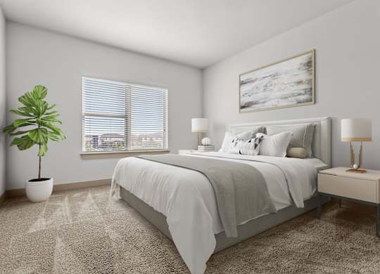 A bedroom with a bed, nightstand, and a plant.