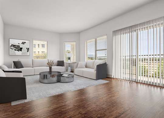 A modern living room with a large window and a view of the outside.