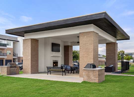 A covered patio area with a table and chairs.