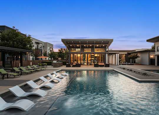 A modern house with a pool in the backyard.