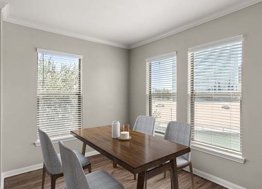 A dining room with a wooden table and chairs.