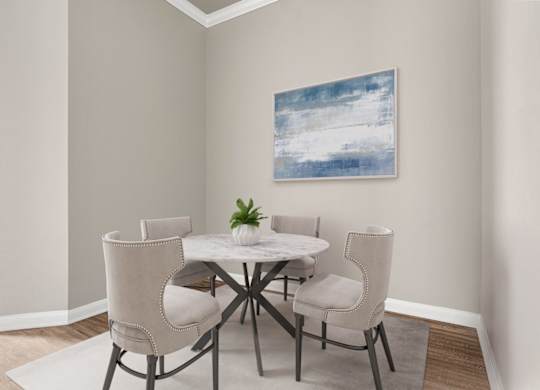 A dining room with a white table and chairs.