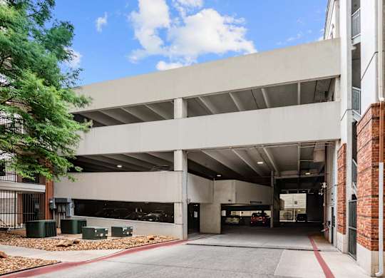 A parking garage with a clear blue sky in the background.