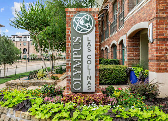 A sign that says Las Colinas in front of a building.