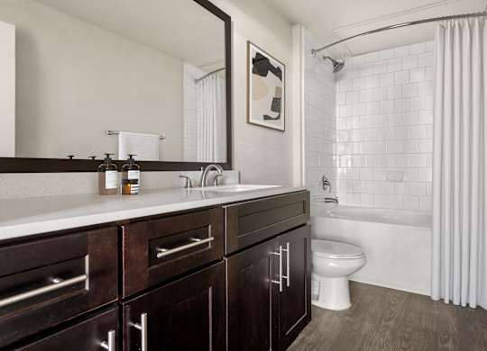A bathroom with a white tub and a white toilet.