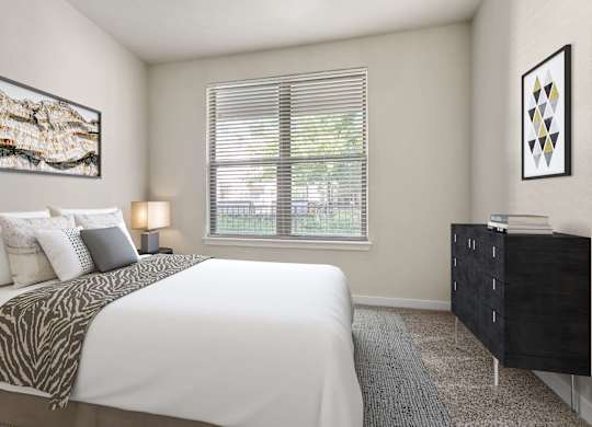 A bedroom with a large bed and a dresser.