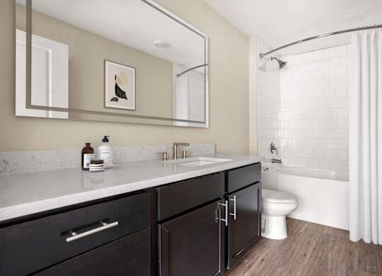 A bathroom with a white sink and a white toilet.
