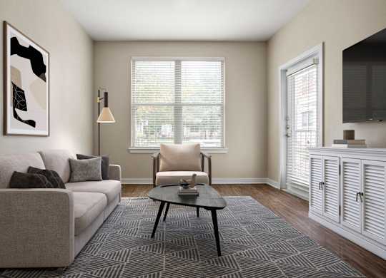 A living room with a couch, chair, and a painting on the wall.