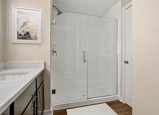 A white bathroom with a walk in shower.