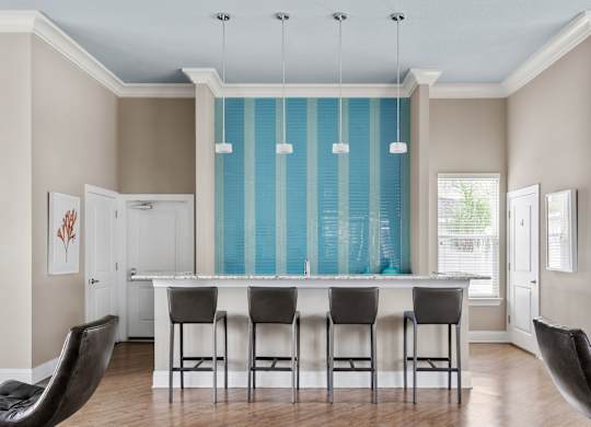 A dining room with a long table and chairs.