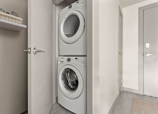 A white washing machine and dryer in a small laundry room.