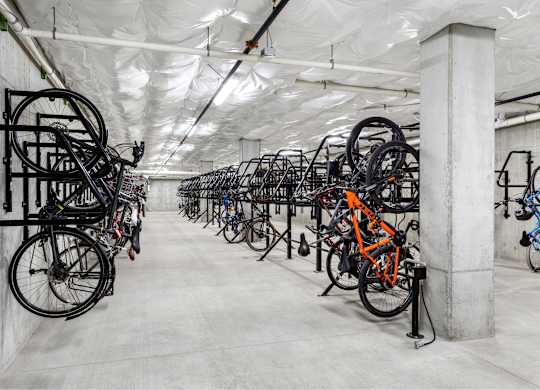 A bike rack with many bicycles parked in it.