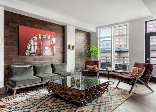 A living room with a couch, chairs, and a coffee table.