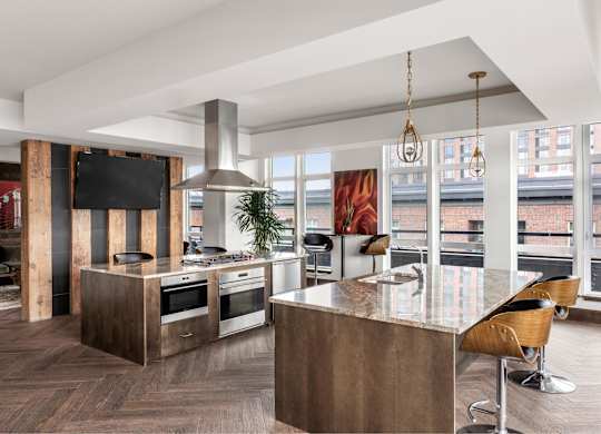 A modern kitchen with a wooden island and bar stools.