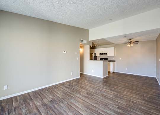 A room with wooden flooring and a ceiling fan.