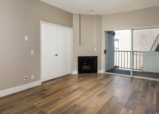 A room with a fireplace and a balcony.