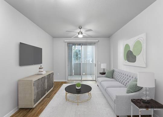 A living room with a grey sofa, a black coffee table, and a television on the wall.