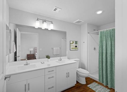 A bathroom with a white vanity and a green shower curtain.