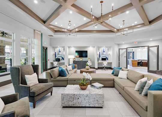 A spacious living room with a variety of seating options and a coffee table in the center.