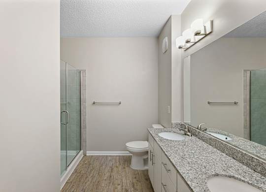 A bathroom with a toilet, sink, and shower.