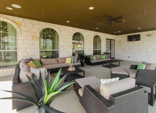 A patio with a table and chairs.
