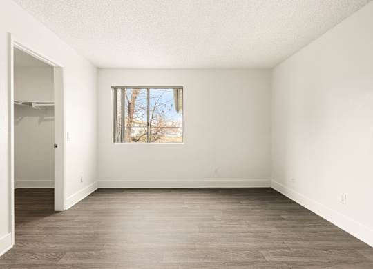 Empty room with a window and a door.