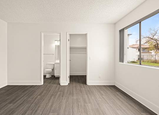 A room with a toilet and a bed in it.