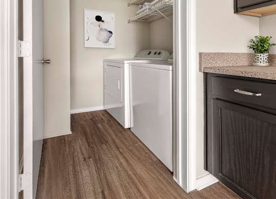 A small laundry room with a washer and dryer.