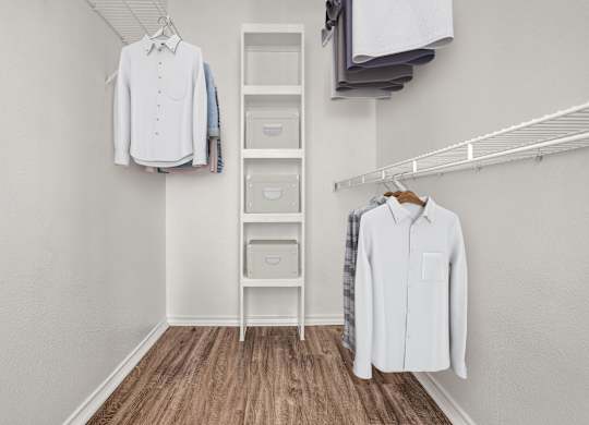 A white shirt is hanging on a rack next to a white ladder.