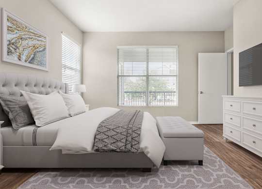 A bedroom with a large bed, a dresser, and a window with blinds.