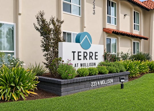 A sign for Terre at Mollison in front of a building.