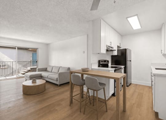 A modern kitchen with a dining table and chairs.