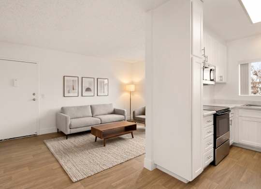 A living room with a grey couch and a coffee table.