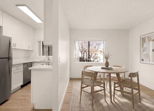 A kitchen with a table and chairs in the middle of the room.