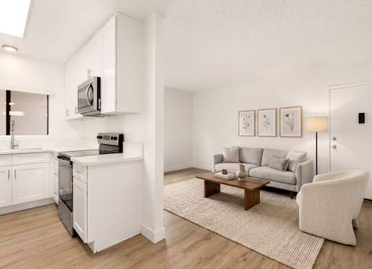 A modern living room with a grey couch and a wooden coffee table.