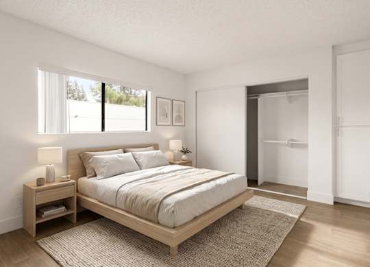 A bedroom with a large bed and a window.