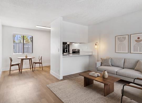 A living room with a dining table and chairs.