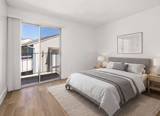 A bedroom with a large bed and a view of the outside.