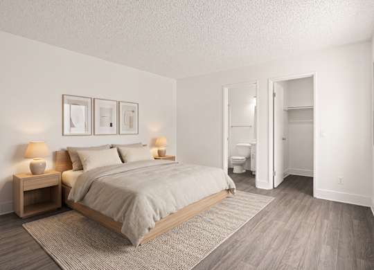 A bedroom with a bed, nightstands, and a bathroom.