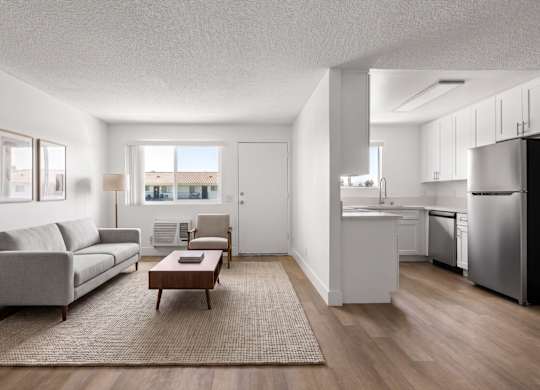 A modern living room with a grey sofa and a coffee table.