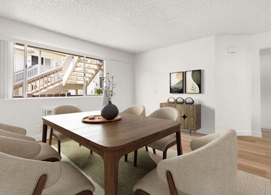 A dining room with a wooden table and chairs.