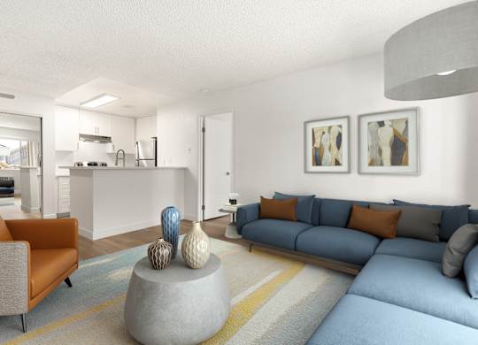 A living room with a grey couch and a grey coffee table with a blue couch and orange pillows.