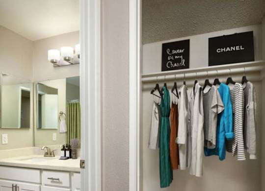 Clothes hanging on a rack in a room.