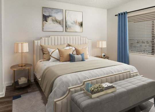 A bedroom with a large bed and two lamps.