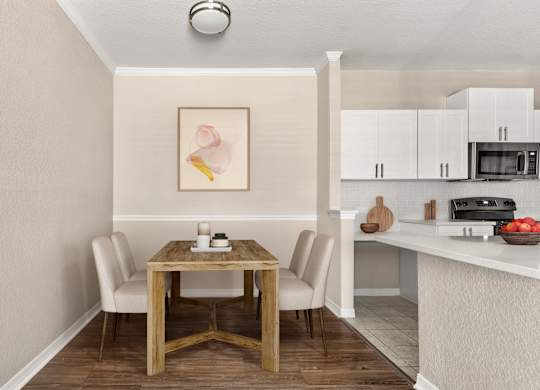 A dining table with chairs and a painting on the wall.