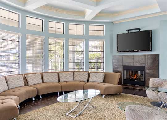 A living room with a fireplace and a television.