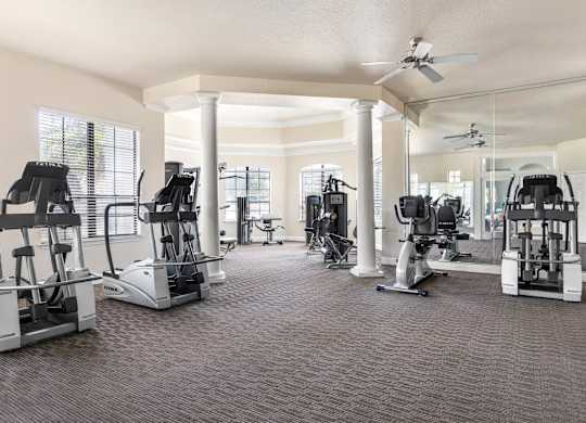 A spacious gym with a variety of exercise equipment.
