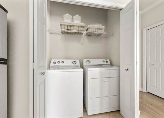 A white laundry room with a washer and dryer.